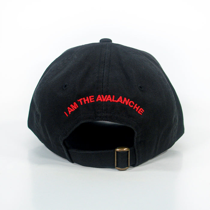 A black dad hat by I Am The Avalanche, shown from the back, features red βI AM THE AVALANCHEβ text above an adjustable strap with a brass buckle.