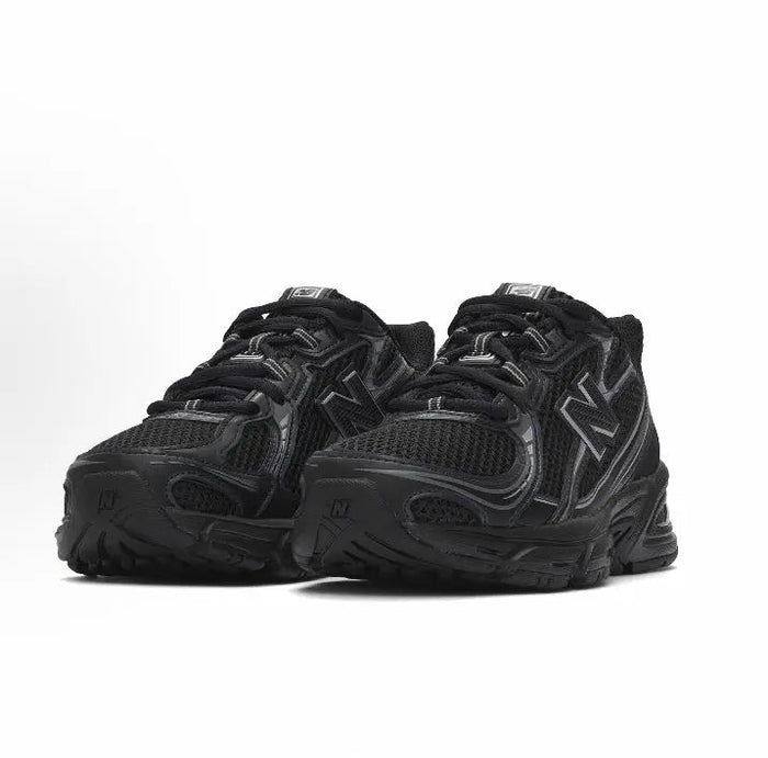 New Balance 740 sneakers, black side view with N branding and chunky sole