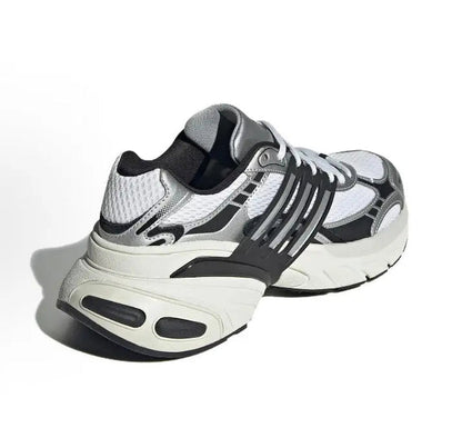 White low-top running shoes with dark gray heel, black stripes, and lace-up closure