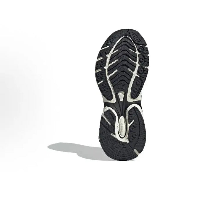 Rubber outsole of white and dark gray running shoes with tread pattern