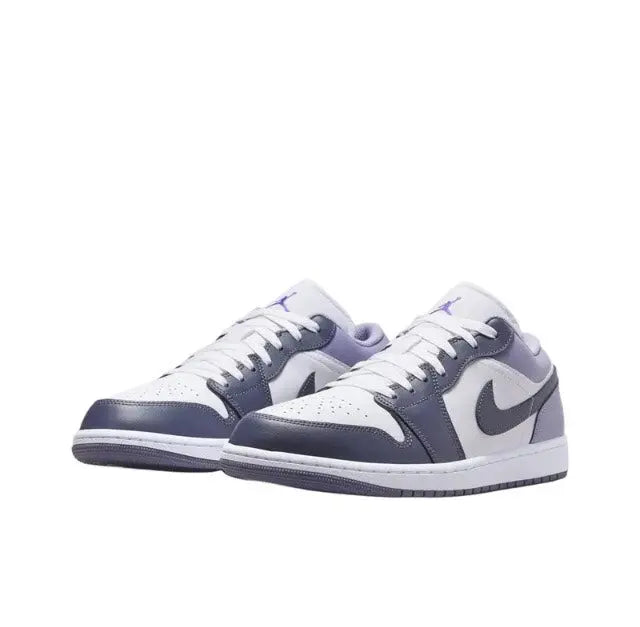 Low-top sneakers with white leather, navy toe and collar, purple laces, and Nike swoosh