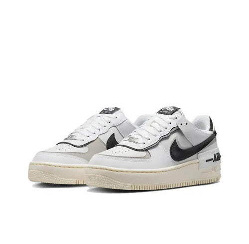 Nike low-top sneakers in off-white leather with black swoosh and gray panels