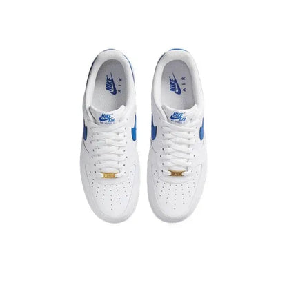 Pair of white low-top sneakers with blue Nike swoosh and lace-up closure