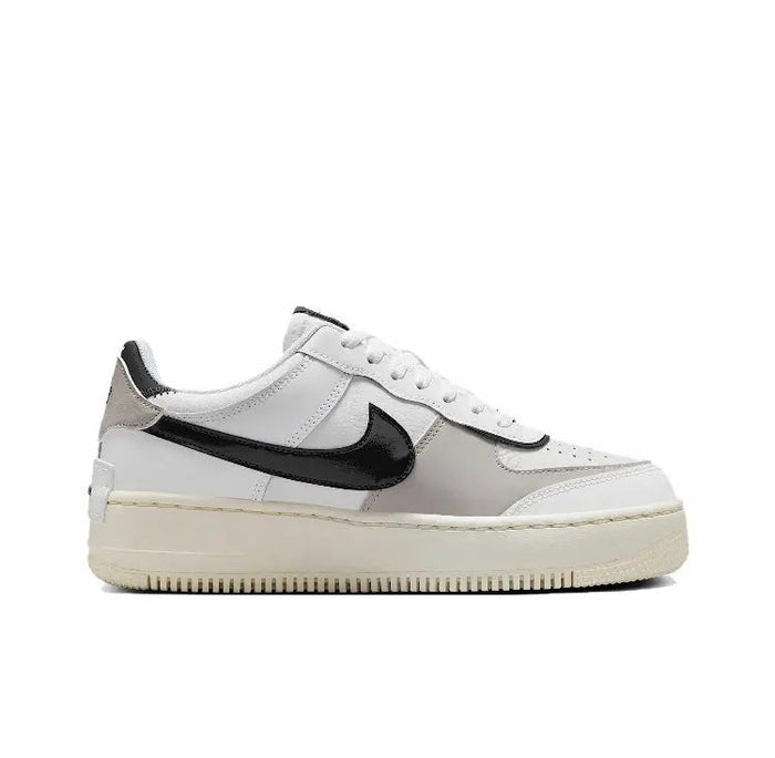 Nike low-top sneakers in off-white leather with black swoosh and cream sole