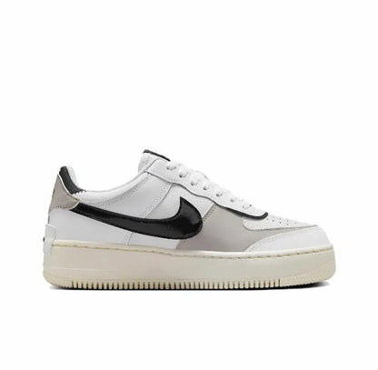 Nike low-top sneakers in off-white leather with black swoosh and cream sole
