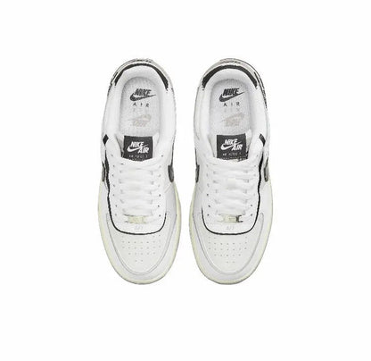 Nike low-top sneakers pair shown from above, white uppers with black accents