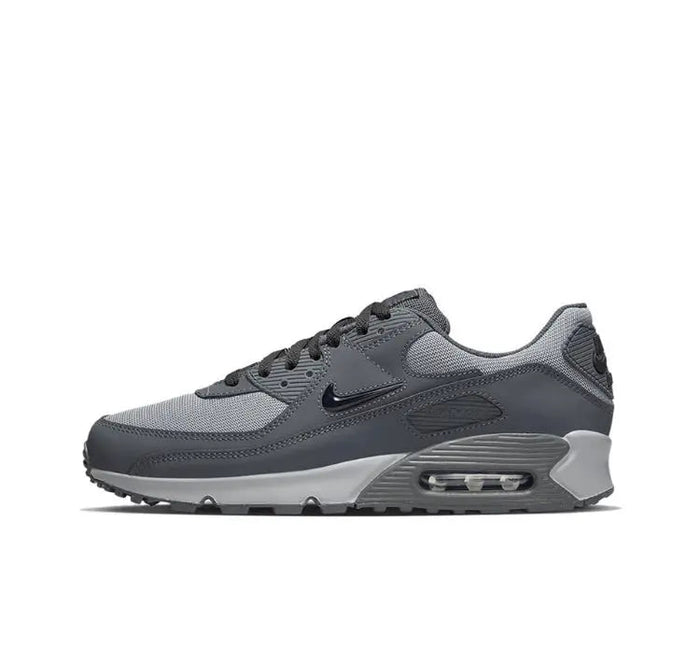 Nike Air Max 90 sneakers in dark gray with black and light gray accents, lace-up