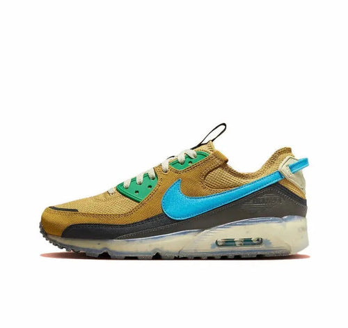 Nike Air Max 90 sneaker in wheat gold with blue swoosh and green laces, visible air unit