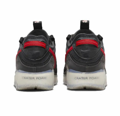 Nike Air Max 90 sneakers, rear view; black heel with red strap and white midsole foam