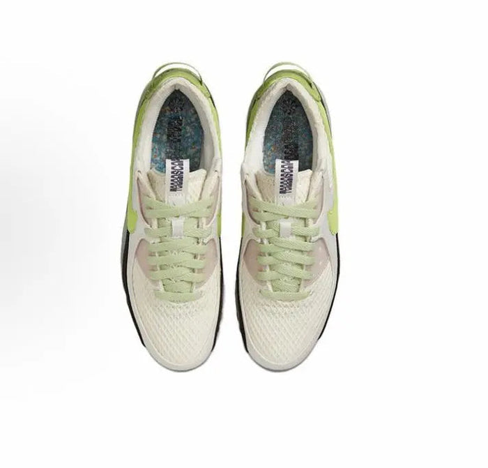 Air Max 90 sneaker pair, cream uppers with green laces and green heel accents