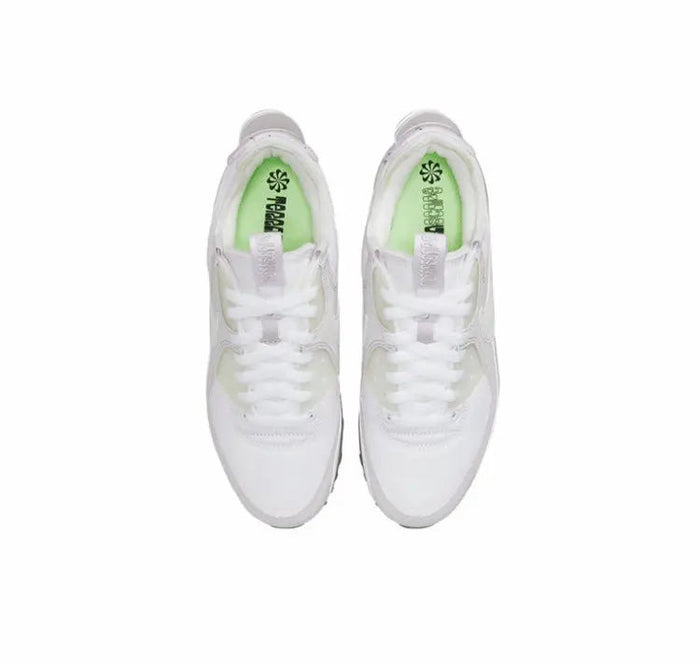 Air Max 90 sneakers, white uppers with lime-green insoles and lace-up tongues.