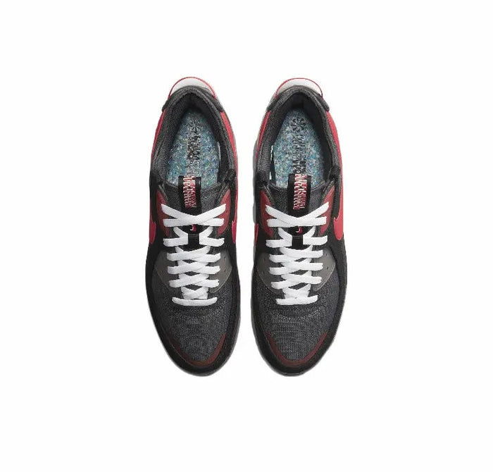 Nike Air Max 90 sneakers, top view; black uppers with red trim and white lace