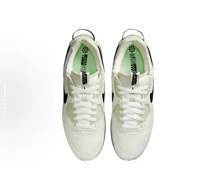 Nike Air Max 90 sneaker pair, white uppers with black detailing and lace-up front