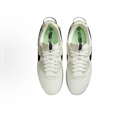 Nike Air Max 90 sneaker pair, white uppers with black detailing and lace-up front