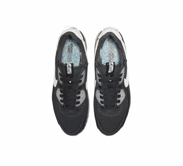 Nike Air Max 90 shoe, black knit upper with white toe overlays and lace-up