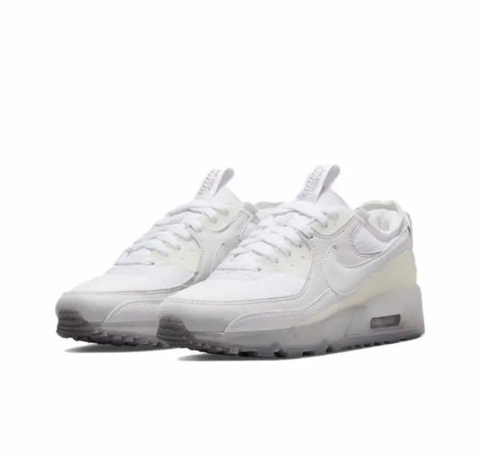 Air Max 90 sneakers, white lace-up style with Nike swoosh and padded tongue.