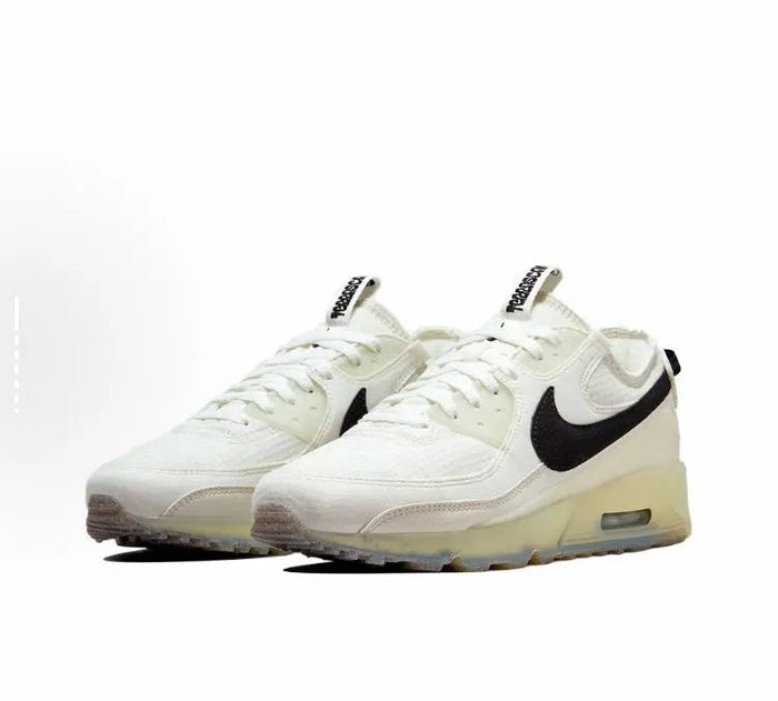 Nike Air Max 90 sneaker pair, pale white with black swoosh and low-profile Air sole