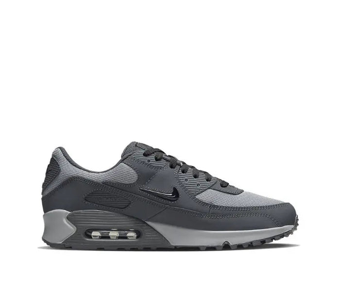 Nike Air Max 90 sneakers side view, dark gray upper with visible Air Max window
