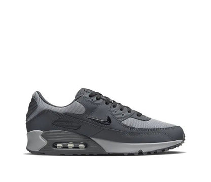 Nike Air Max 90 sneakers side view, dark gray upper with visible Air Max window