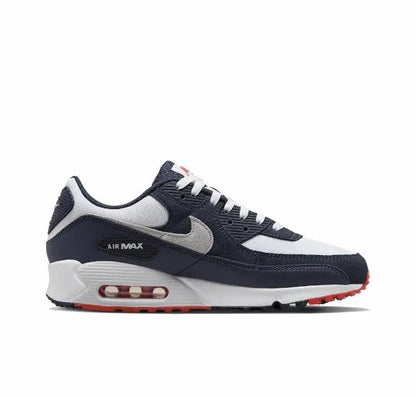 Nike Air Max 90 side profile with navy upper, grey swoosh, white midsole, red Air window