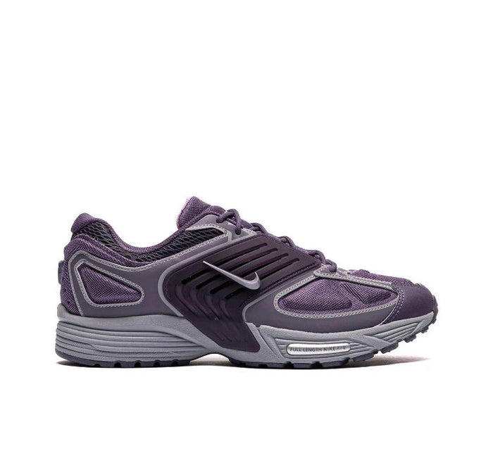 Nike running shoe in dark purple and gray, lace-up with swoosh logo