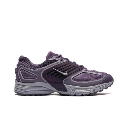Nike running shoe in dark purple and gray, lace-up with swoosh logo