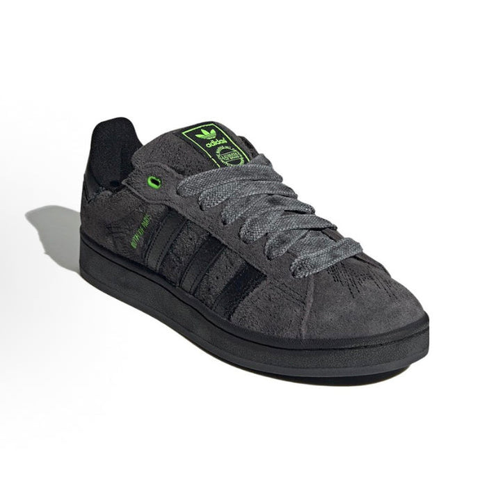 Black suede Adidas Campus sneakers with green logo accents and lace-up front