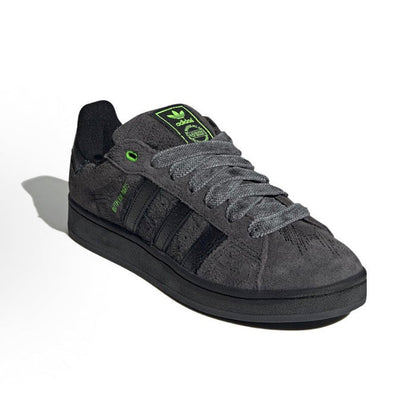 Black suede Adidas Campus sneakers with green logo accents and lace-up front
