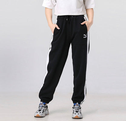 Black track pants with side white stripe, drawstring waist, elastic ankle cuffs.