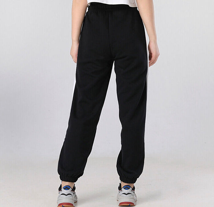 Black relaxed track pants with elastic waistband and cuffed ankles.