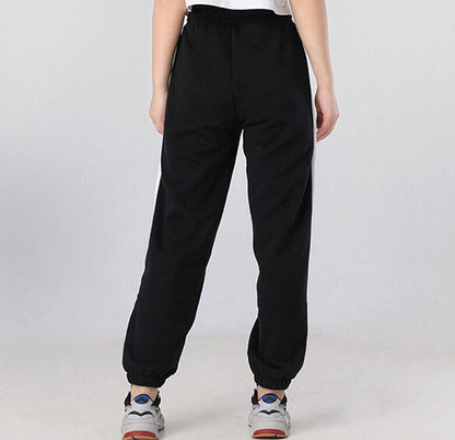 Black relaxed track pants with elastic waistband and cuffed ankles.
