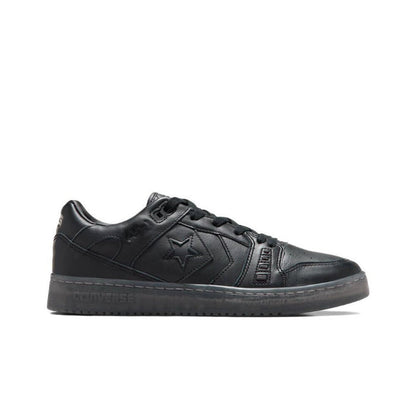 Black low-top sneakers side view, lace-up with star panel and rubber cupsole