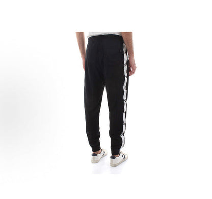 Black track pants with white side stripe panel and tapered ankle cuffs