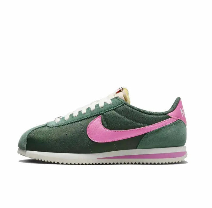 Nike Cortez sneakers in dark green with pink swoosh and white laces