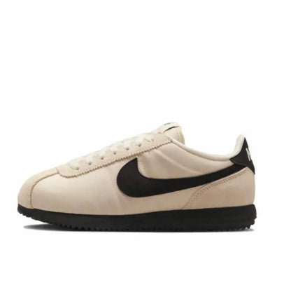 Nike Cortez sneakers in light beige with black swoosh and black rubber sole