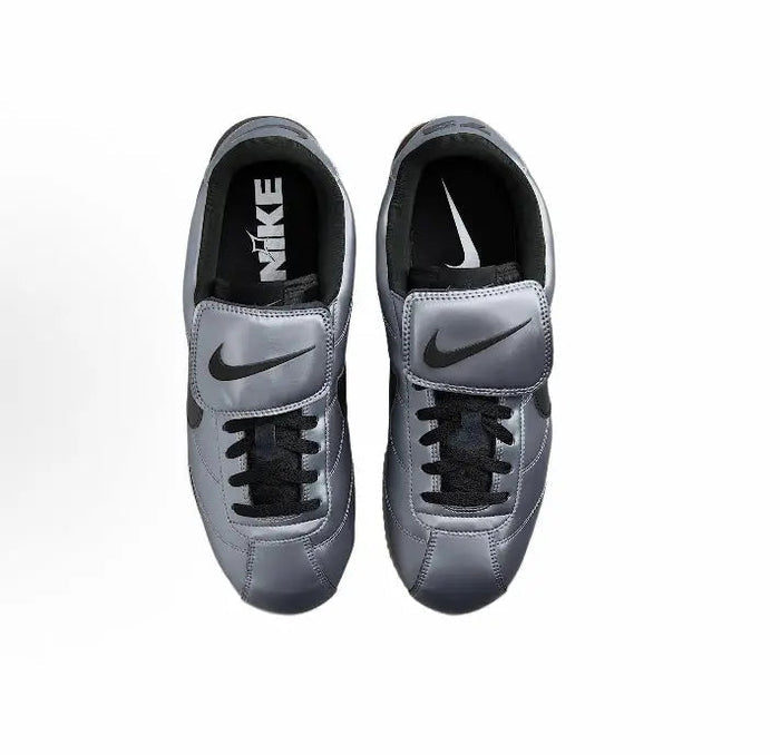 Nike low-top sneakers with grey uppers, black laces, and black Swoosh details