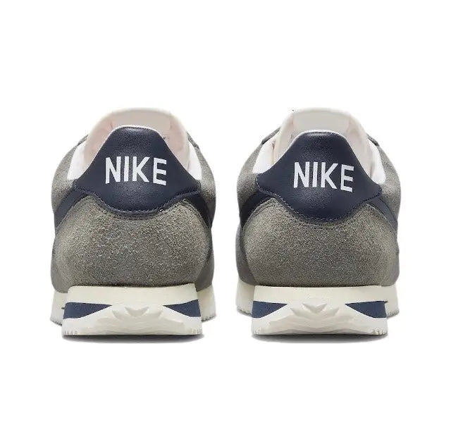 Grey Nike Cortez sneakers with NIKE heel branding and white midsole