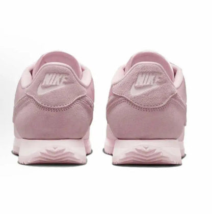 Pink Nike Cortez sneakers with NIKE branding on heel and flat rubber sole