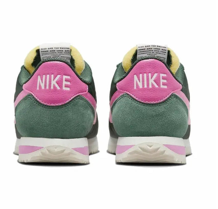 Nike Cortez sneakers with pink heel tab, NIKE logo, and green suede