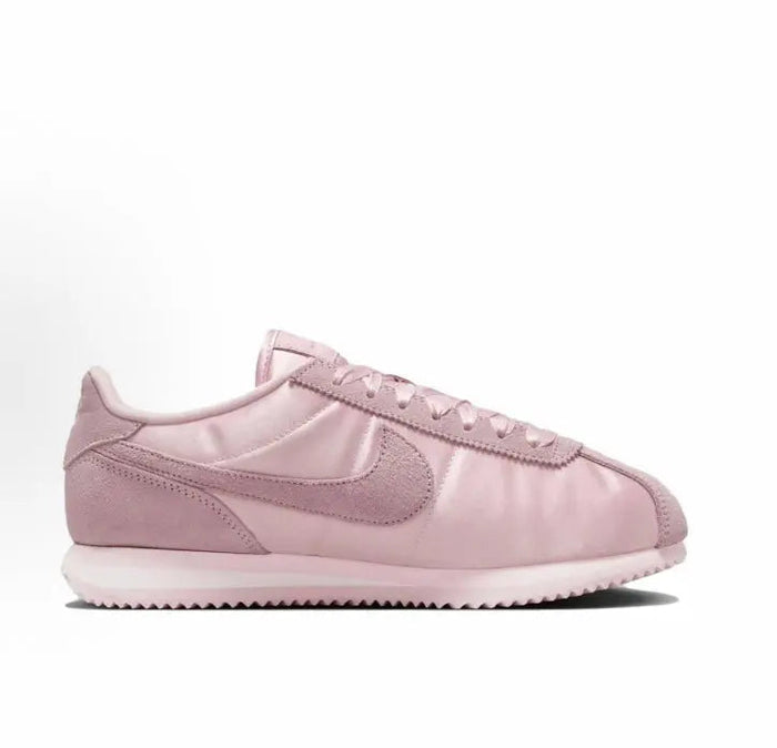 Pink Nike Cortez low-top sneakers with glossy toe panel and Swoosh logo