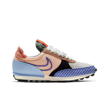 Nike Day Break sneaker in beige with blue swoosh, striped panels, and orange heel accents
