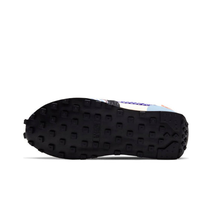 Nike Day Break sneaker outsole view with dark tread and blue details at the heel