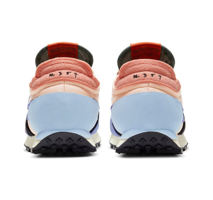 Nike Day Break sneaker heel view with light blue suede, orange collar trim, and dark tread