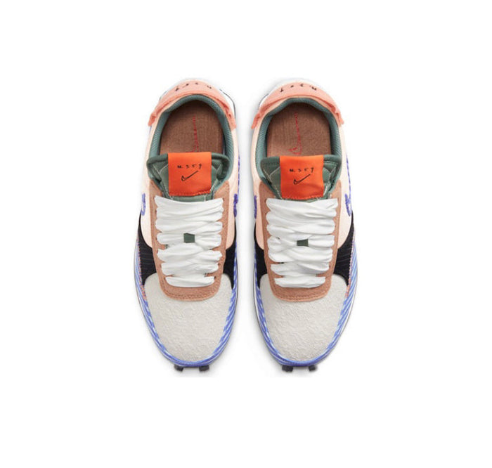 Nike Day Break sneaker top view with white laces, cream uppers, and blue trim at toe