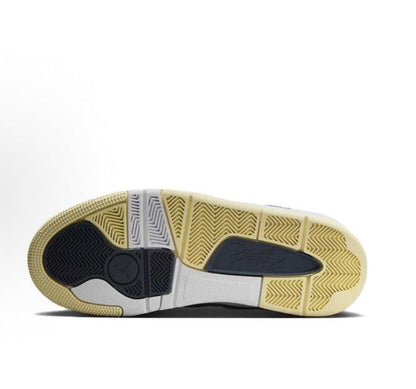 Traction outsole with white and tan rubber segments and blue inserts