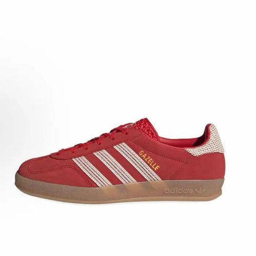 Red Adidas Gazelle Indoor sneaker with white stripes and gum sole, lace-up.