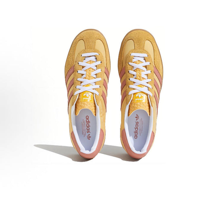 Gazelle Indoor sneakers front view, yellow uppers with pink stripes and white lace