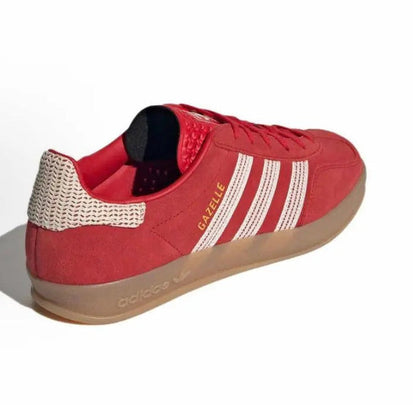Red Adidas Gazelle Indoor sneaker with white stripes, knitted collar, and padded heel.