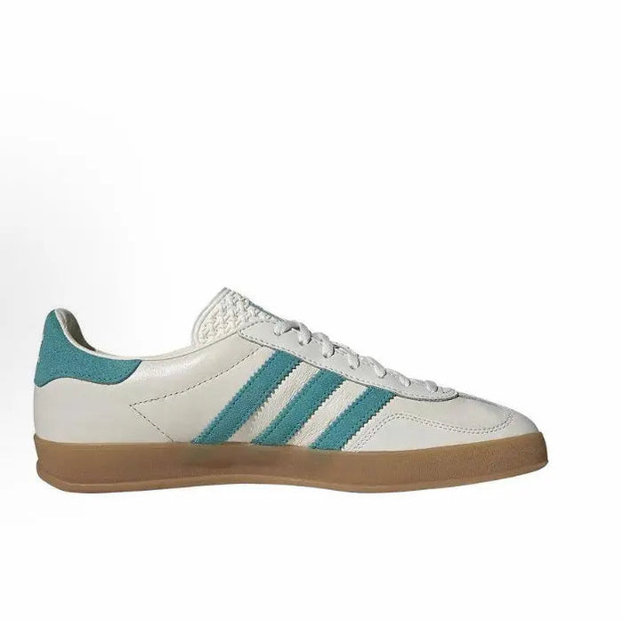 Adidas Gazelle sneakers, white leather with teal stripes and lace-up front, gum sole