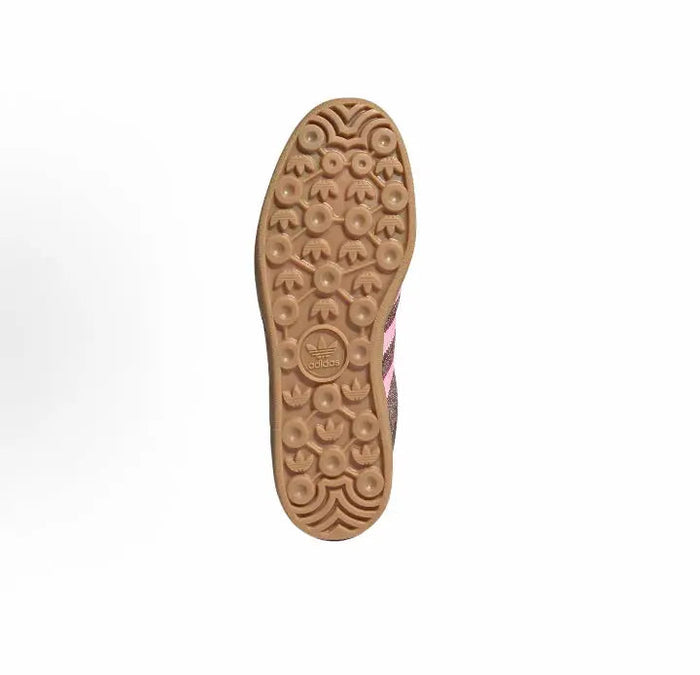 Adidas sneaker outsole with gum rubber tread and circular traction pattern